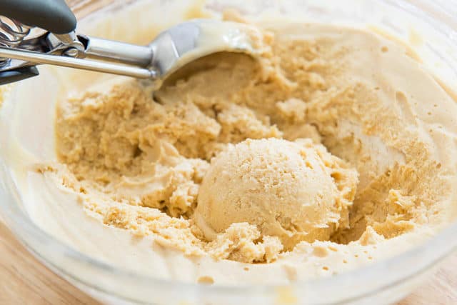 Peanut Butter Semifreddo - In a Glass Bowl with a Scoop Partially Taken with Cookie Scoop
