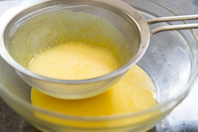 Straining the Sugar Egg Yolk Mixture Through a Fine Mesh Strainer