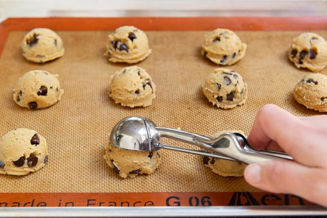 Portioning Out the Cookie Dough with a Cookie Scoop on Silicone Mat