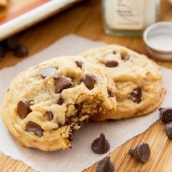 Chocolate Chip Cookies Served on Wax paper on Wooden board