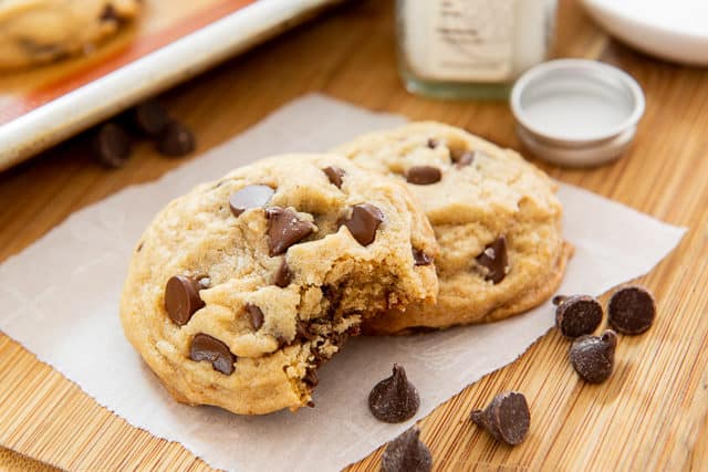 Easy Chocolate Chip Cookies - Served on Parchment Paper with Chocolate Chips on Wooden Board