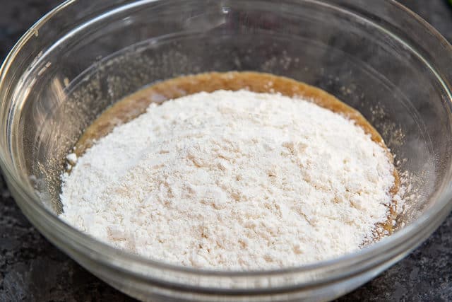 Flour Added to the Wet Ingredients in Glass Bowl