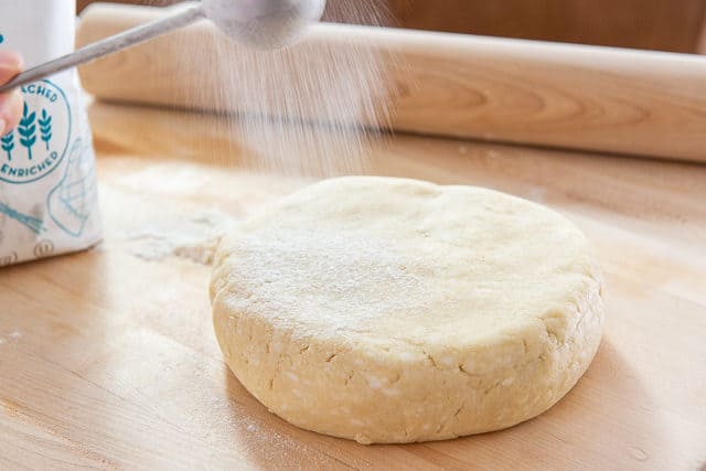 Dusting Pie Dough Recipe with Flour on Wooden Board