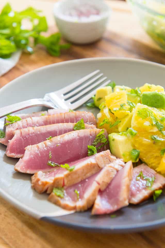 Seared Ahi Tuna Sliced Thinly On a Plate with Orange Salad