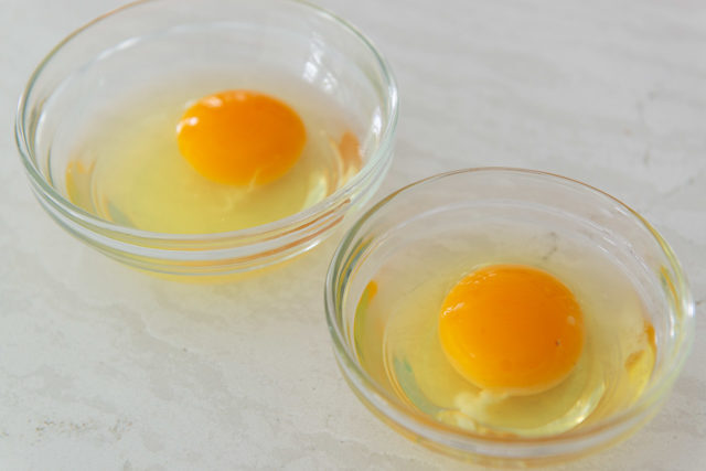 Two Cracked Eggs in Small Glass Bowls
