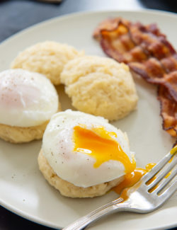 How to Poach an Egg - End Result on a Plate with Biscuits and Bacon