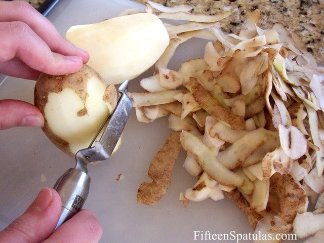 Peeling Russet Potatoes on a Cutting Board