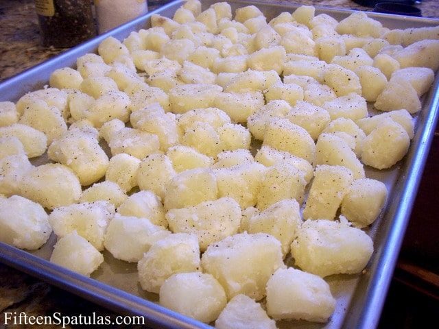 Potato Chunks Spread On A Sheet Pan and Seasoned with Salt and Pepper