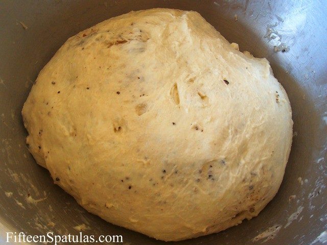 Raw Bread Dough Round with Cracked Pepper and Cheese Chunks