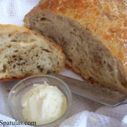 Parmesan Peppercorn Bread - Sliced and Served With Freshly Whipped Butter in Bowl