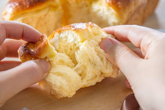 Brioche Recipe - Being Torn Apart with Hands to Show Fluffy Texture