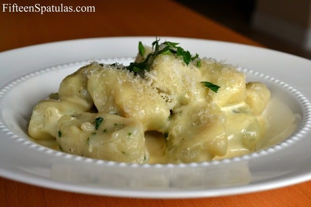 Potato Gnocchi - Served in White Bowl and Sprinkled with Herbs and Parmesan