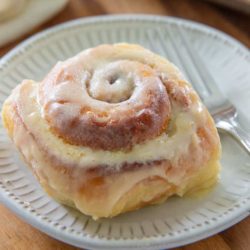 Cinnamon Roll on a White Ceramic Plate with Fork