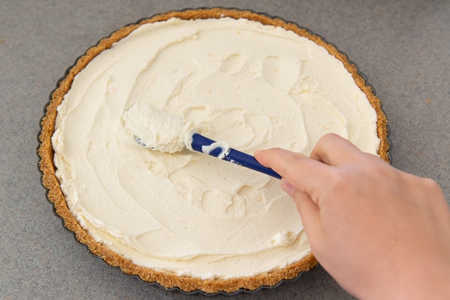 No Bake Mascarpone Tart - With Graham Cracker Crust and Mascarpone Filling Being Spread Inside with Spatula