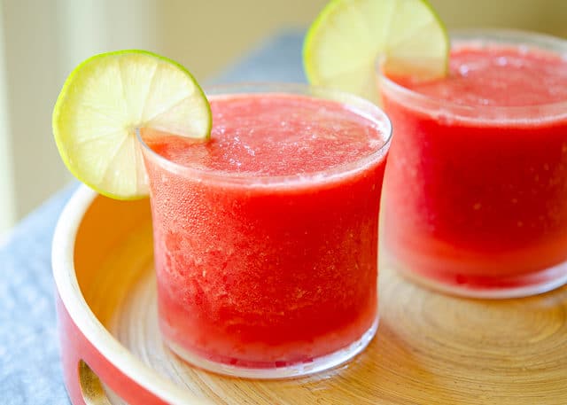 Watermelon Slushie Recipe - Served in Glasses on Wooden Tray with Lime Wedge Garnish