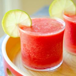 Watermelon Slushies Poured in a Glass with Lime Wedge Garnish