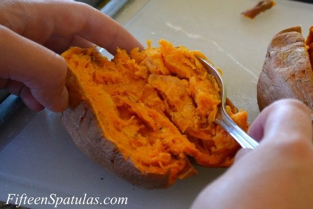 Scooping out cooked sweet potato for donuts