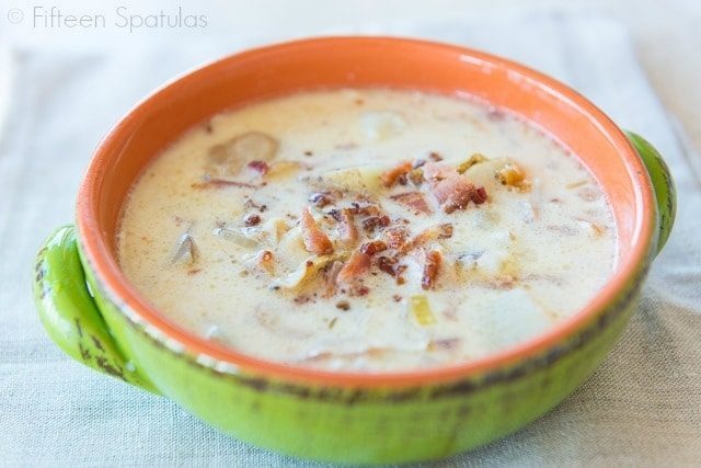 New England Clam Chowder Recipe - Served in a Green Bowl with Bacon On Top