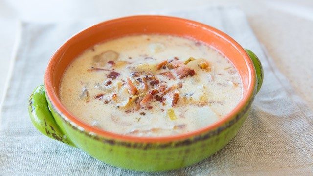 New England Clam Chowder - In a Green Bowl with Bacon Garnish On Top