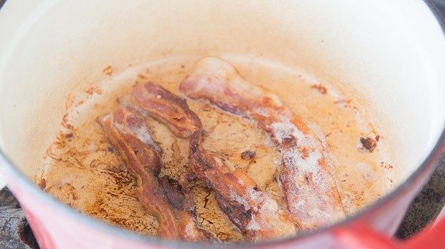 Crispy bacon strips and rendered fat in dutch oven