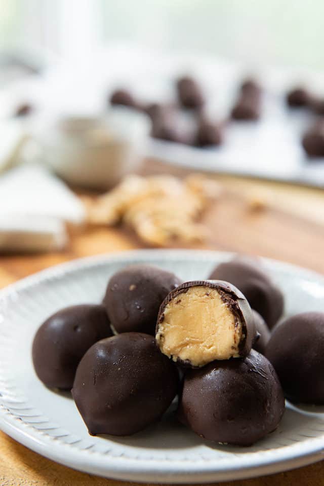 Peanut Butter Balls - Stacked on a White Plate with Filling Shown