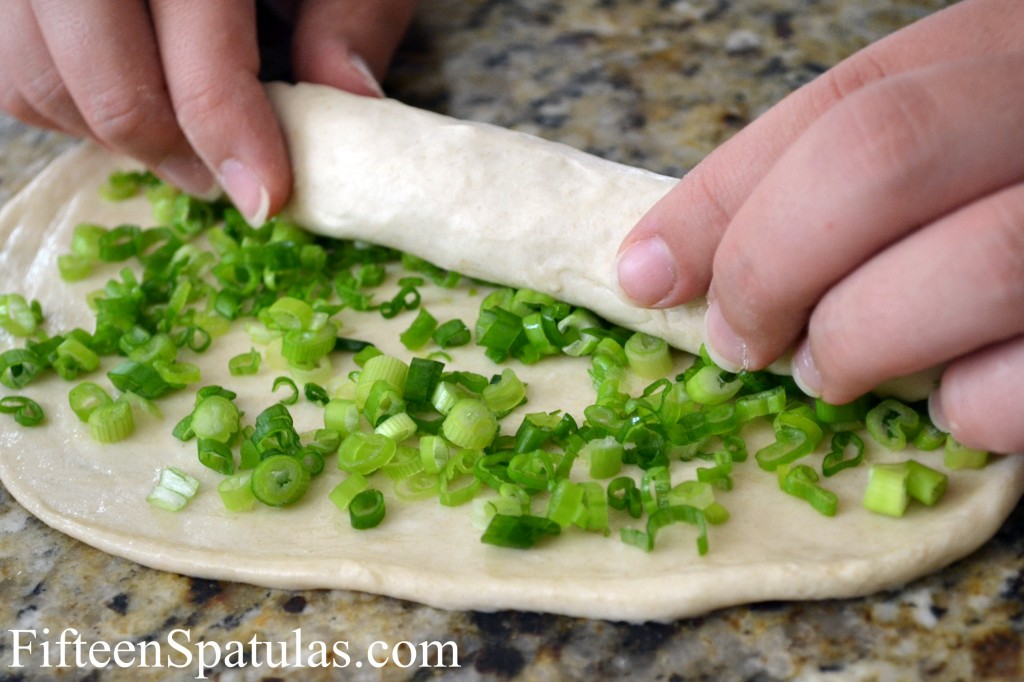Rolling up the Pancake to enclose the scallions