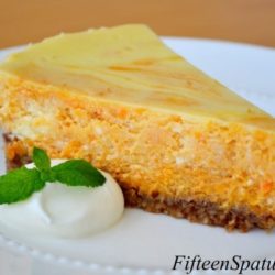 Sweet Potato Cheesecake - Sliced and Served on White Plate with Whipped Cream and Mint Sprig