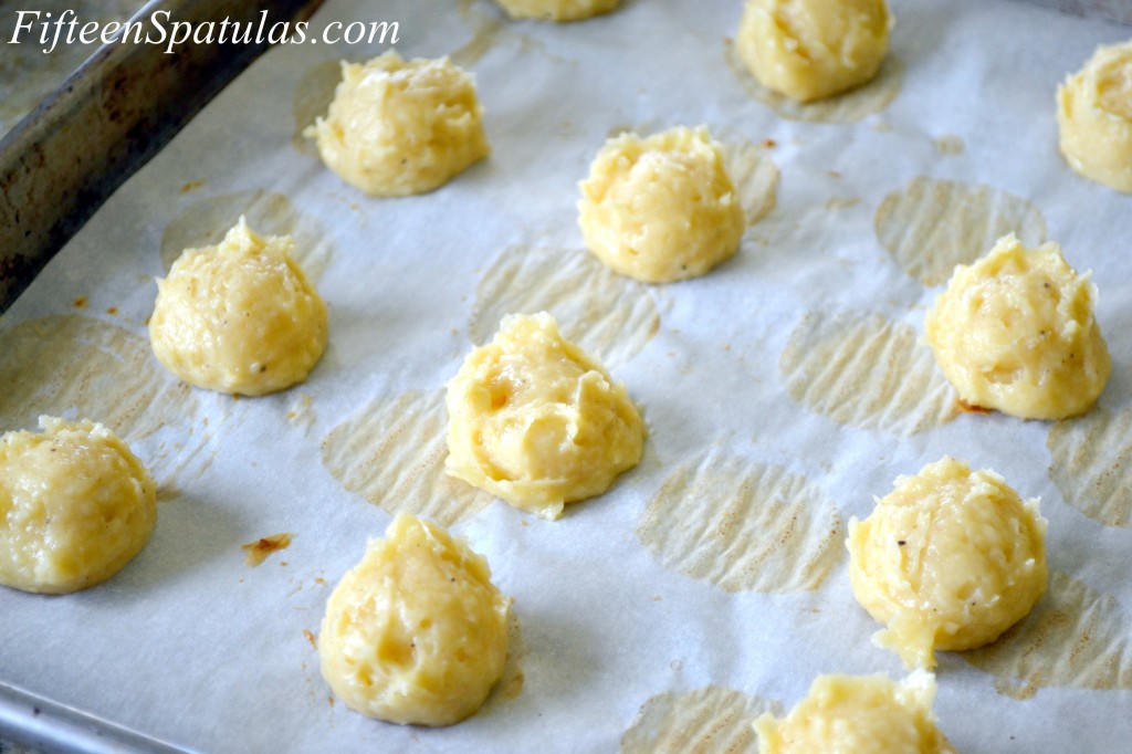 Scooped Cheese Puffs Gougeres In Rows on Parchment Paper Lined Tray