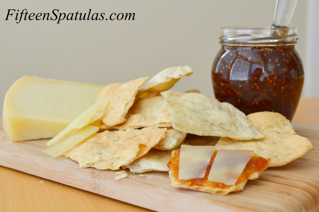 Rosemary Cracker Recipe Batch on Wooden Board with Fig Jam and Manchego Cheese