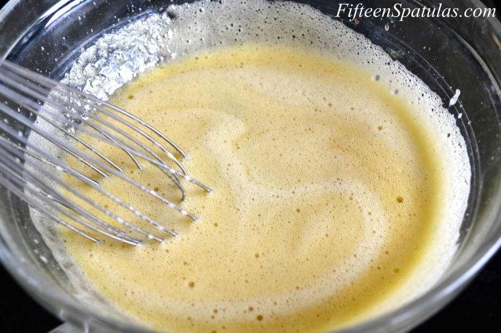 How to Make Ice Cream Without An Ice Cream Maker - Whisk Egg Yolks and Sugar in Bowl over Heat Until Yolks Thicken and Lighten and Look Frothy on Top