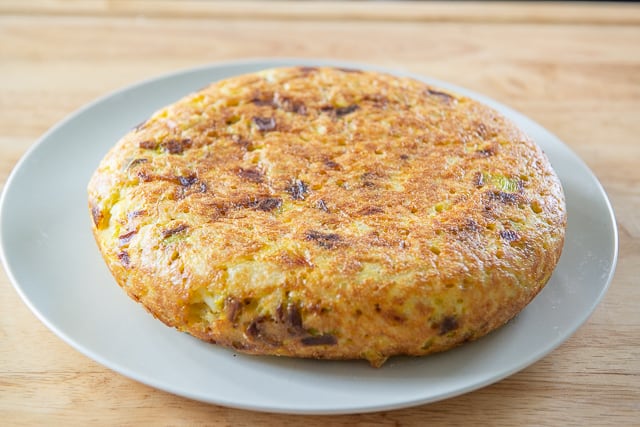 Spanish Potato Tortilla - On Plate and Ready to Be Sliced and Served