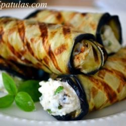 Eggplant Ricotta Rolls - Stacked on White Plate with Basil Garnish