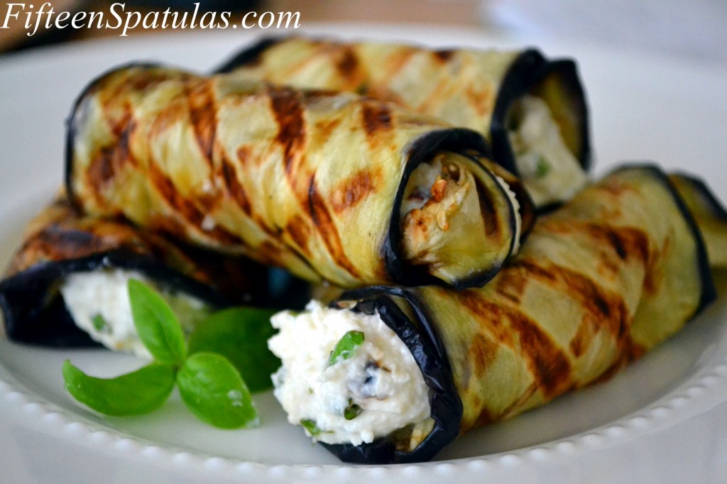 Eggplant Ricotta Rolls - Stacked on White Plate with Basil Garnish