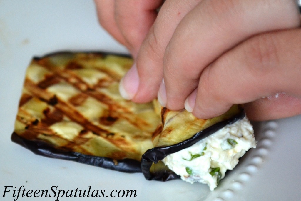 Rolling up Ricotta Stuffed Grilled Eggplant Slices with Fingers