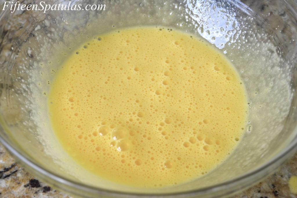 Frothy and Lightened Egg Yolk Mixture in Glass Mixing Bowl
