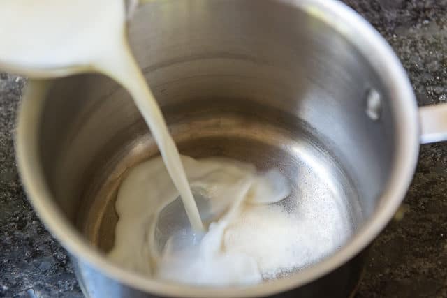Pouring milk and Gelatin Into a Saucepan