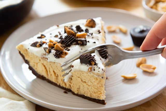 Peanut Butter Pie Recipe - Sliced and Served on Gray Plate with Fork Cutting Through
