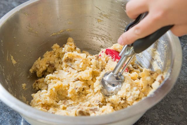 Scooping the Chorizo Cheese Mashed Potato Filling with a Cookie Scoop
