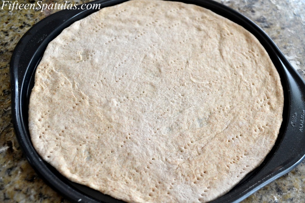 Pricked Pizza Dough on Pizza Pan