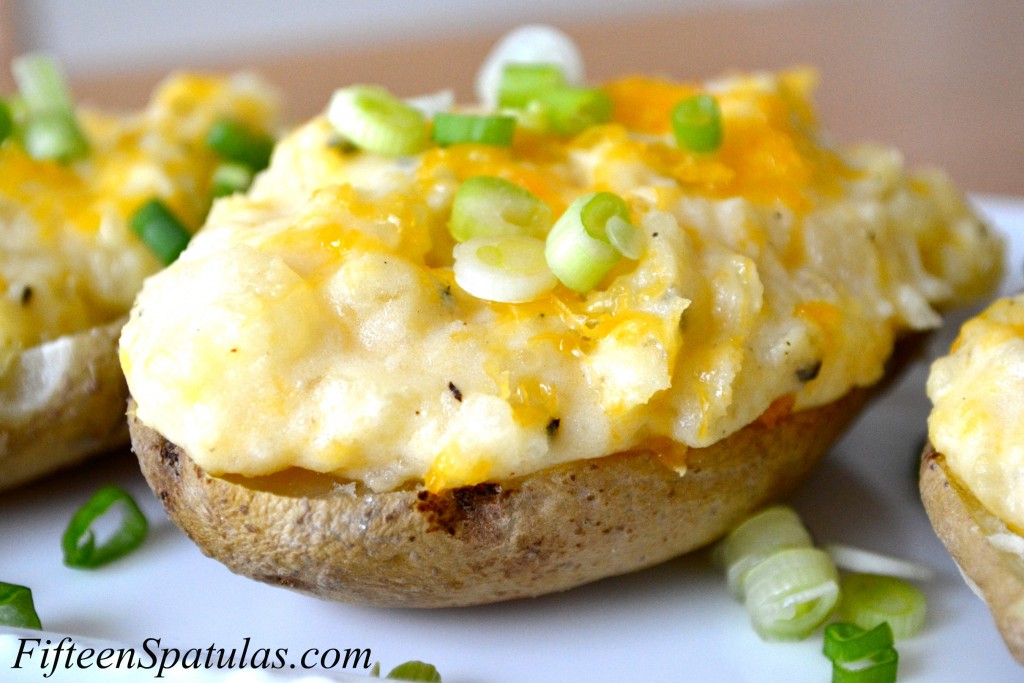 Potato Boats - On a White Platter and Sprinkled with Cheese and Scallions