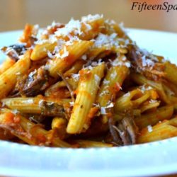Short Rib Pasta - In White Bowl with Parmesan Cheese Sprinkled on Top and Short Rib Ragu throughout