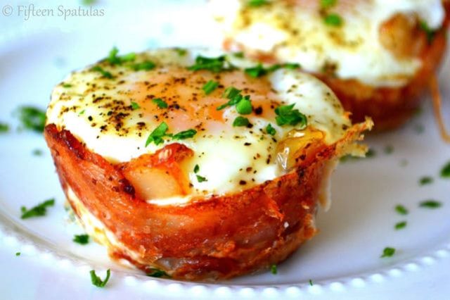 Bacon Wrapped Egg Cups - On White Dish and Sprinkled with Parsley