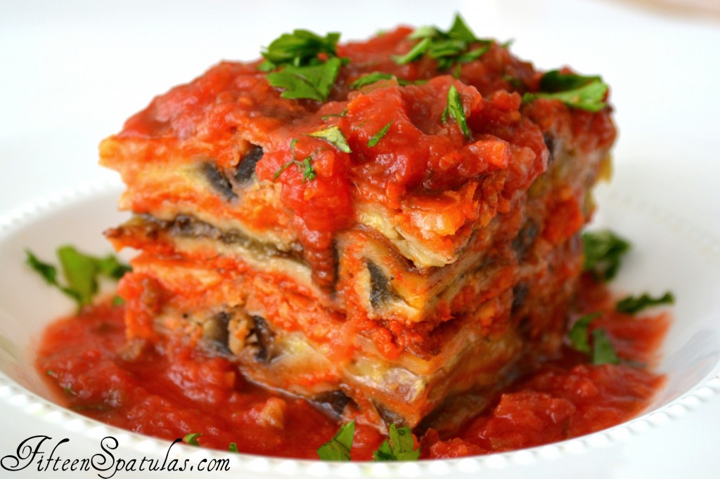 Eggplant Parmesan Stacks - In White Bowl with Extra Sauce on Top and Parsley Sprinkled on Top