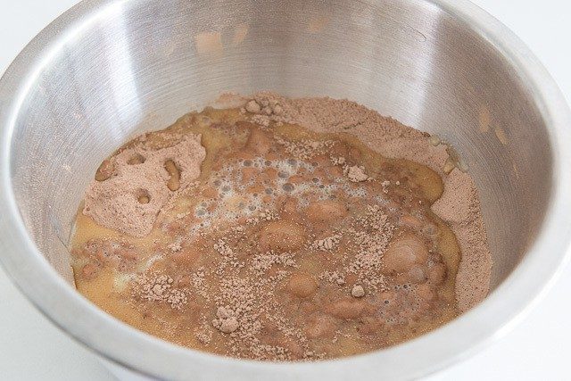 Dry Cocoa Flour Mixture in Bowl Mixed with Wet Ingredients