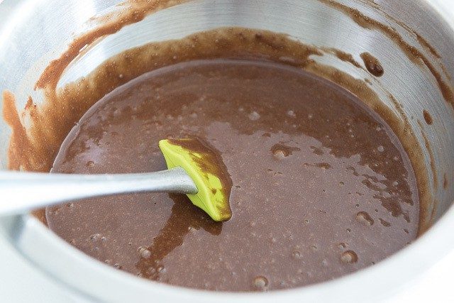 Coffee Mixed Into Chocolate Cupcake Batter in Mixing Bowl with Spatula