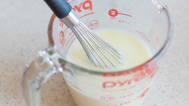 Wet Ingredients for Pancakes in Glass Pyrex Measuring Cup