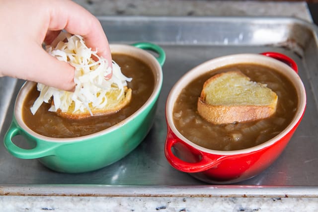 Adding Shredded Gruyere Cheese to the French Onion Soup