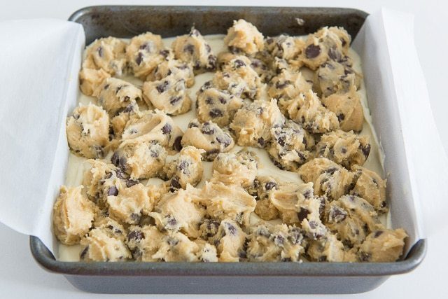 Clumps of Chocolate Chip Cookie Dough Dropped Onto cheesecake Filling