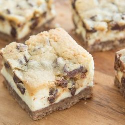 Chocolate Chip Cheesecake Bars - Cut Into Squares on Wooden Board
