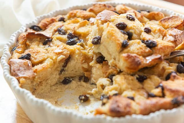 Bread Pudding Recipe - In a White Dish with Raisins and Showing Moist Interior